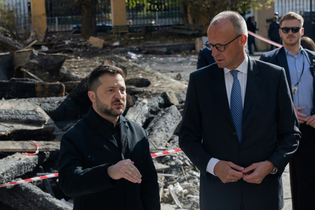 Ukraine's President Volodymyr Zelensky showed German Chancellor Friedrich Merz the National Academy of Science which was hit on Tuesday — Tetiana DZHAFAROVA / AFP