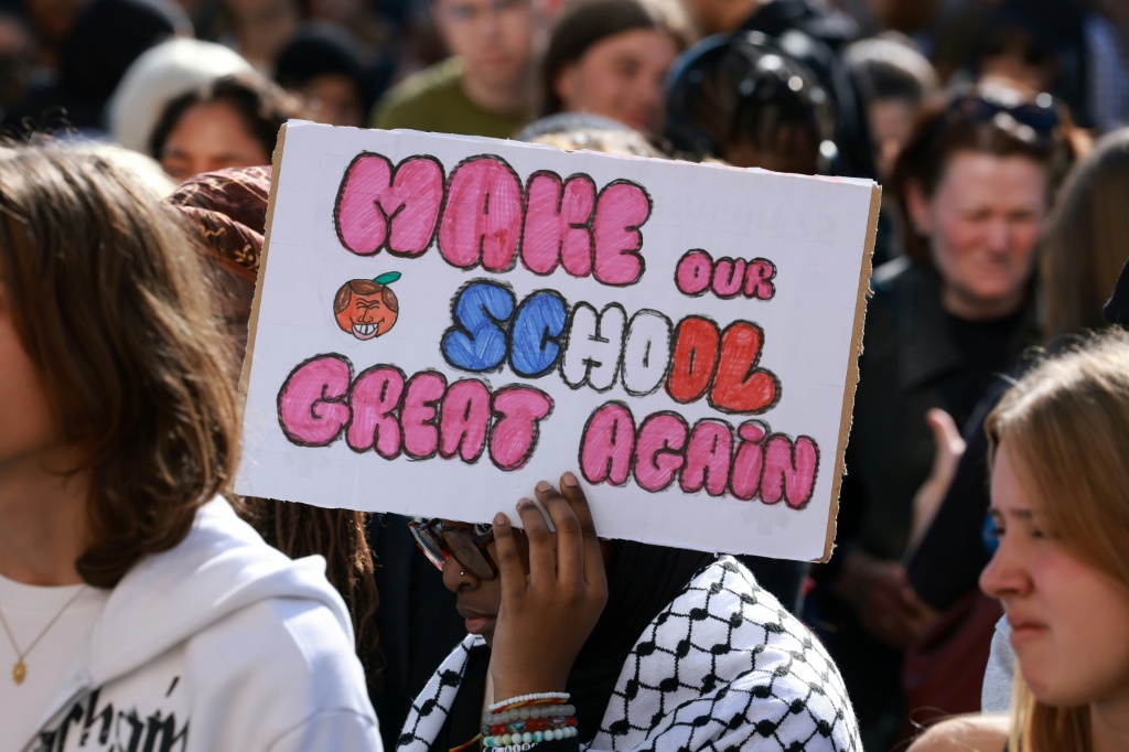 At Saint-Denis, just north of Paris, students took turns expressing their grievances at an open-air meeting Sunday — Kenzo TRIBOUILLARD / AFP