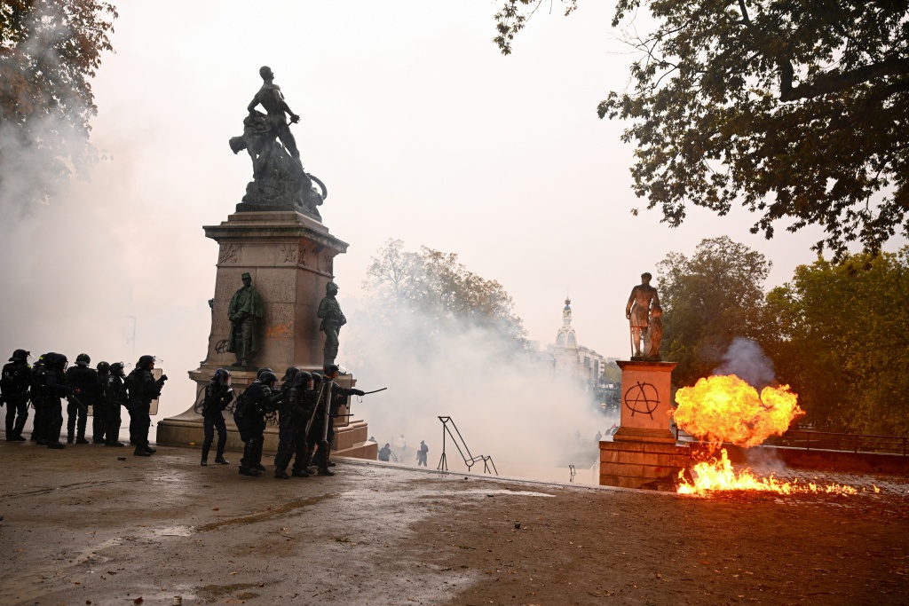 A firebomb explodes near police in the city of Nantes — Guillaume Saligot / AFP