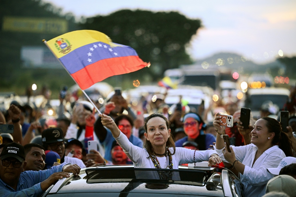 Venezuelan opposition leader and Nobel Peace Prize laureate Maria Corina Machado greets supporters  in Caracas after almost a year in exile — Federico PARRA / AFP