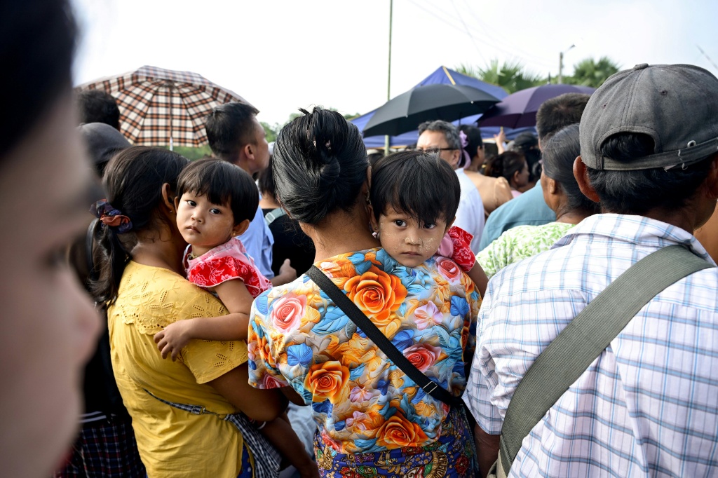 Many families who had gathered outside the base were told they would have to wait to see their relatives who would be transported to different parts of the Yangon region after arriving in Myanmar — Sai Aung MAIN / AFP