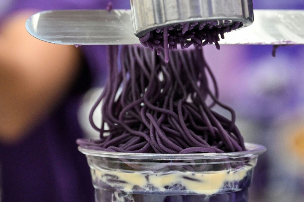 Ube halaya topping over sweet ube rice porridge (champorado) is a popular treat in the Philippines — Jam STA ROSA / AFP