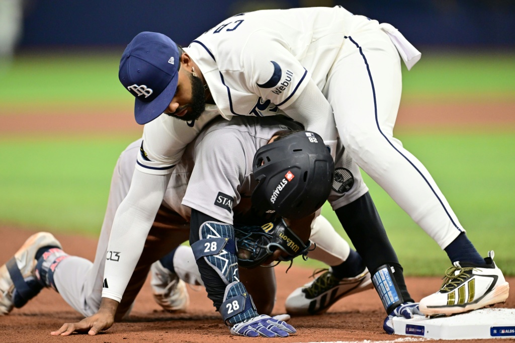 Junior Caminero of the Tampa Bay Rays tags out New York's Austin Wells at third base in the Rays' MLB playoff win over the Yankees — Julio Aguilar