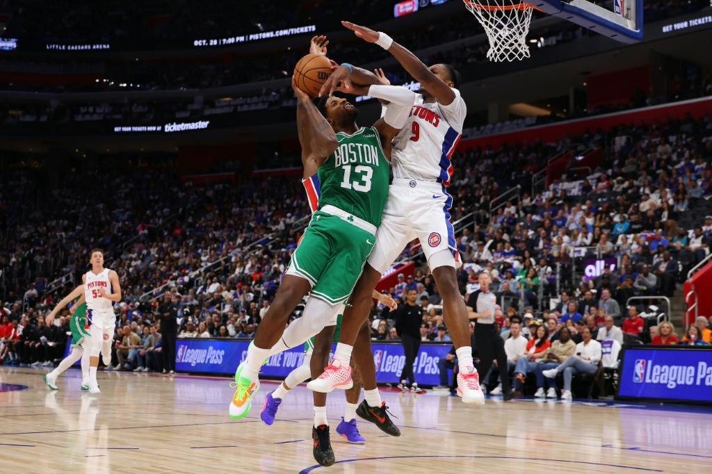 Boston's Paul George, center, drives to the basket against Detroit's Ausar Thompson on his way to scoring a game-high 38 points but the Celtics lost to the host Pistons in the opening game of the NBA season — Gregory Shamus