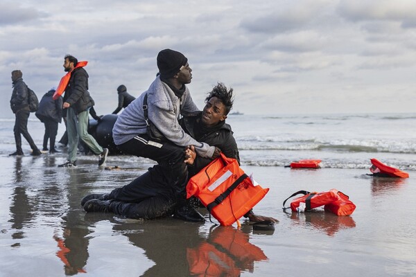 A Sudanese migrant reacts on the shore after leaving a smuggler's boat, which was punctured by French police officers to prevent migrants from embarking in an attempt to cross the English Channel, on the beach of Gravelines, near Dunkirk, northern France on April 26, 2024. 