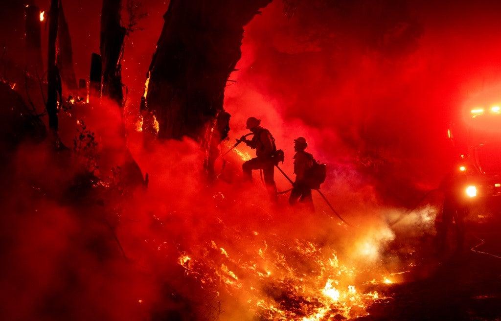 Firefighters work to control flames from a backfire during the Maria fire in Santa Paula, California on November 1, 2019. Josh Edelson / AFP