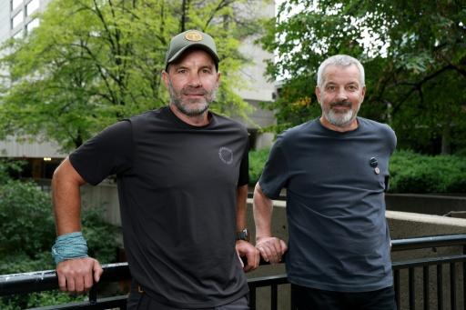 Romanian athlete Tiberiu Useriu (L) and his brother Alin Useriu (R) now lead an NGO dedicated to environmental and social projects — VALERIE MACON / AFP