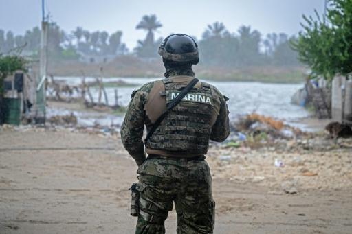A member of the Mexican Navy stands near a flooded area in the town of Puerto San Carlos, in Mexico's Baja California Sur state, as Hurricane Polo batters the region — Carl de Souza / AFP