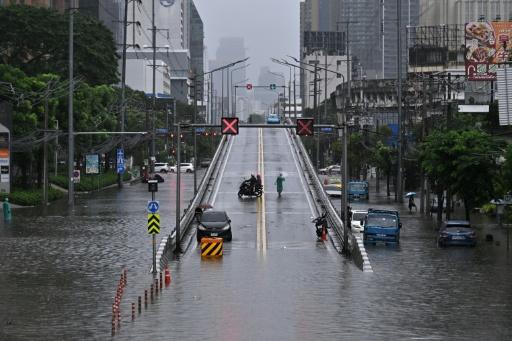 A person tends to their flooded shop in the Bang Bua district of Bangkok on September 26, 2026. — WIKUS DE WET / AFP