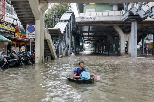 A man looks out from a flooded restaurant in Bangkok on September 26, 2026 — Lillian SUWANRUMPHA / AFP