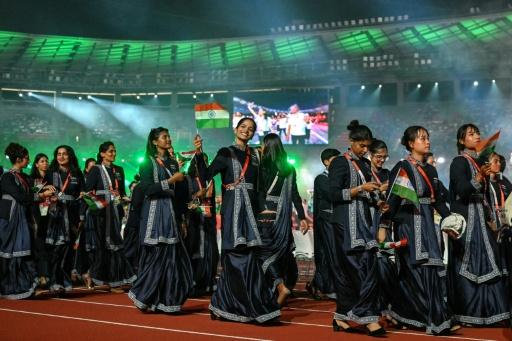 Members of India's delegation wave their country's national flag — MOHD RASFAN / AFP