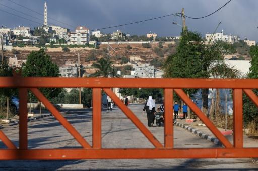 Palestinian pupils cross one of the gates erected at the entrance of the village of Qusra, south of the city of Nablus in the Israeli-occupied West Bank, on September 6, 2026, the first day of new academic year. — JAAFAR ASHTIYEH / AFP