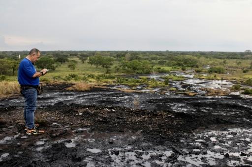 Hector Valero Balestrini walks over crude oil seeping to the surface at Cerro Miosa — Margioni BERMÚDEZ / AFP