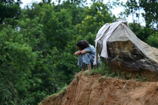 Un enfant est assis seul près d’un centre d’apprentissage temporaire géré par l’organisation caritative Save the Children pour les enfants séparés de leurs parents lors de crues dans le district de Nuwakot, au Népal, le 11 septembre 2026 — Prakash MATHEMA / AFP